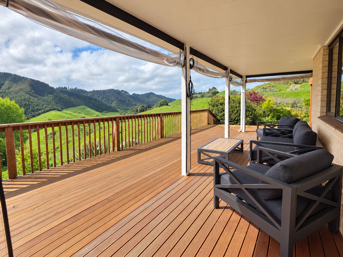 Covered deck with outdoor sofas looking down the valley